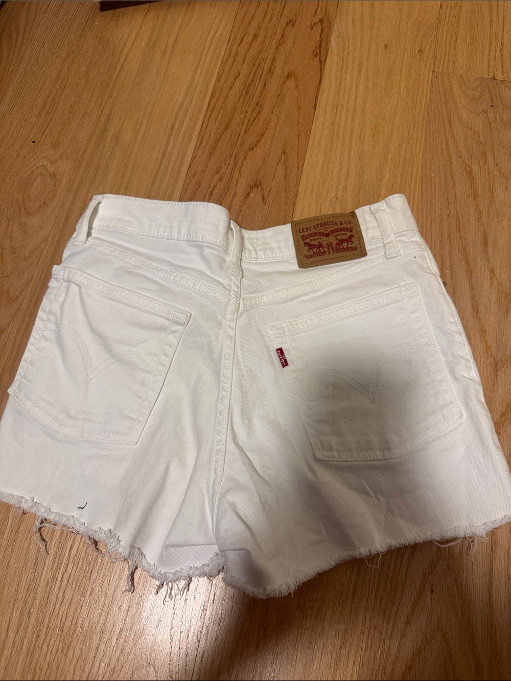 Levi's White Denim Cutoff Shorts with Frayed Hem